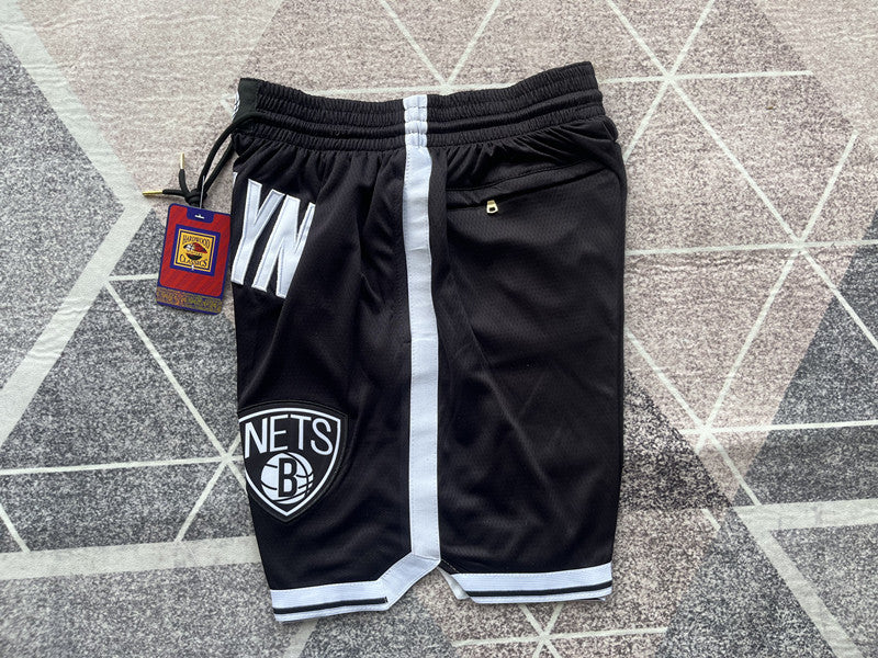 Black Brooklyn Nets premium basketball shorts, side panel detail