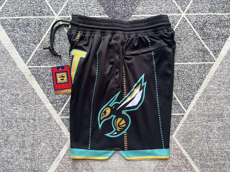 Black Charlotte Hornets premium basketball shorts, side panel detail