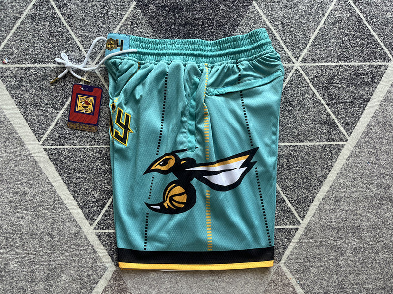 Green Charlotte Hornets premium basketball shorts, side panel detail
