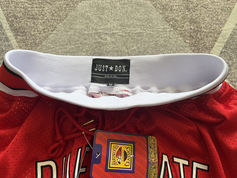 Red Generic Style premium basketball shorts, waistband and label detail
