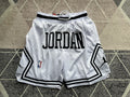 White Jumpman premium basketball shorts, full front view