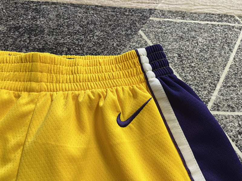 Yellow LA Lakers basketball shorts, waistband and logo detail