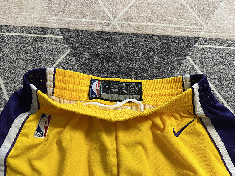 Yellow LA Lakers basketball shorts, waistband and label detail