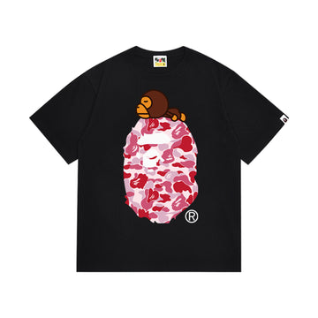 Black graphic T-shirt, pink camouflage ape-head graphic with a small brown cartoon character, front view