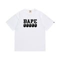 White graphic T-shirt, bold black lettering above five small ape-head graphics, front view
