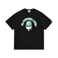 Black graphic T-shirt, green outlined arched lettering and green ape graphic, front view