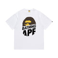 White graphic T-shirt, brown and yellow ape graphic above stacked black lettering, front view