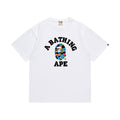 White graphic T-shirt, arched black lettering and multicolor camouflage ape-head graphic, front view