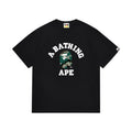 Black graphic T-shirt, arched white lettering and green camouflage ape-head graphic, front view