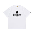 White graphic T-shirt, black ape-head graphic above lowercase lettering and tokyo text, front view