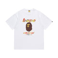 White graphic T-shirt, brown and yellow ape-head graphic with multicolor lettering, front view