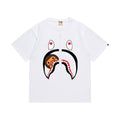 White graphic T-shirt, large shark-face graphic with a small brown cartoon character, front view