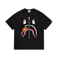 Black graphic T-shirt, large shark-face graphic with a small brown cartoon character and a vertical zipper motif, front view