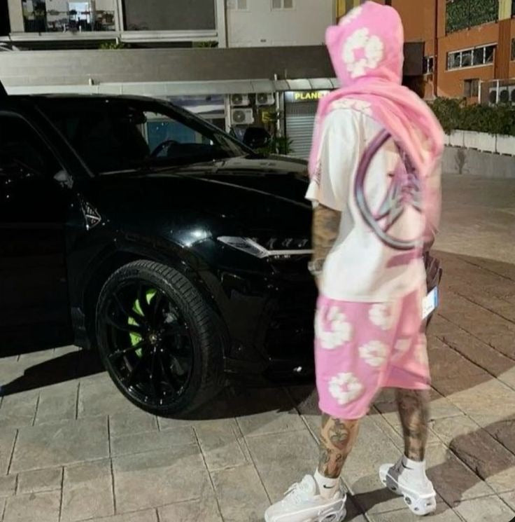 Pink floral shorts styled beside a black vehicle
