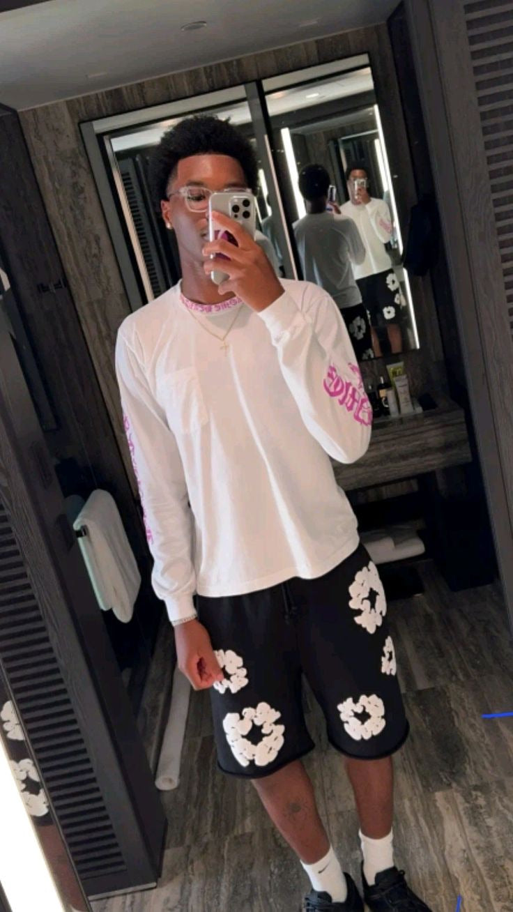 Black floral shorts styled in a mirror selfie